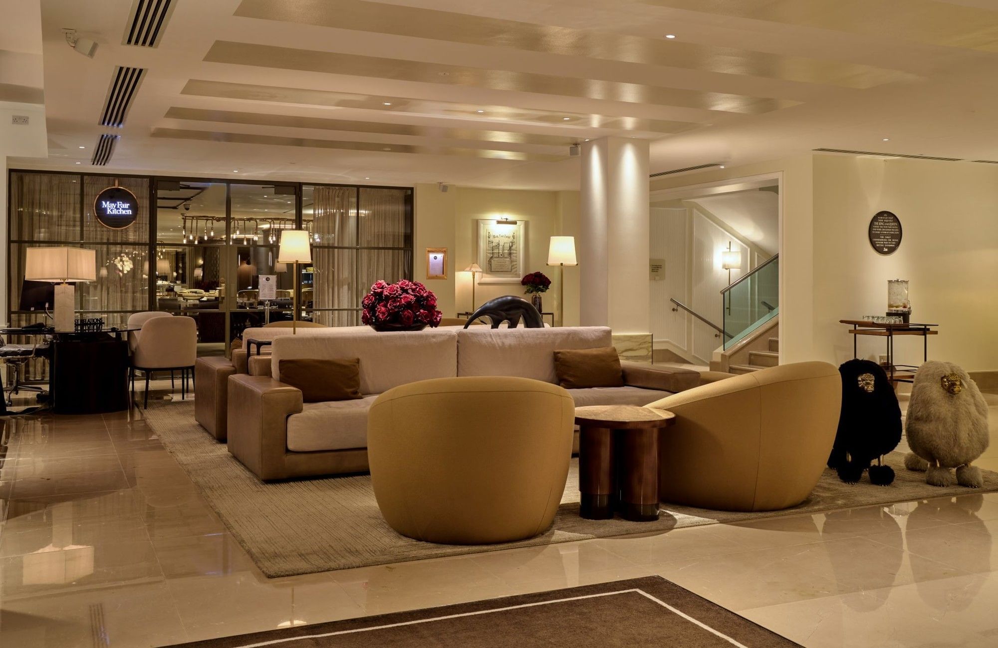 Elegant lounge area with plush seating and modern decor at The May Fair Hotel. 