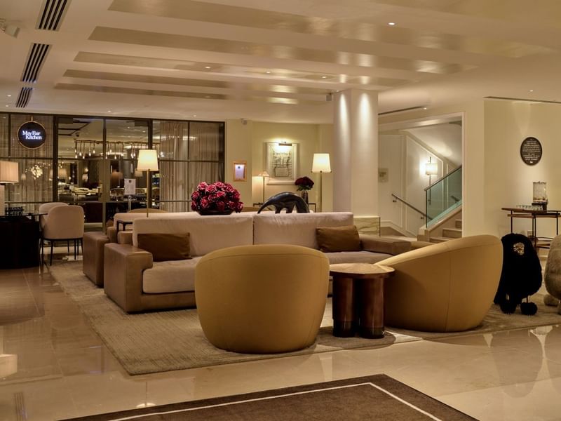 Elegant lounge area with plush seating and modern decor at The May Fair Hotel. 