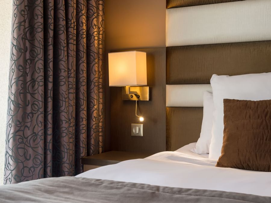 Closeup pillow on bed in a room at Hotel du Golf de l'Ailette