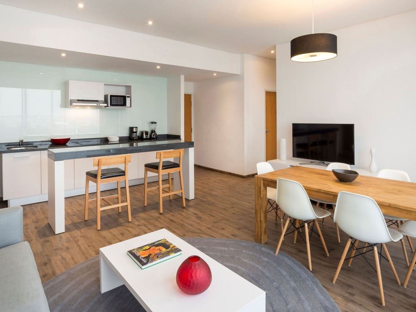 King Bed and 2 Double Beds Suite 2 Rooms featuring a modern kitchenette and a dining table at Camino Real Puebla Angelopolis