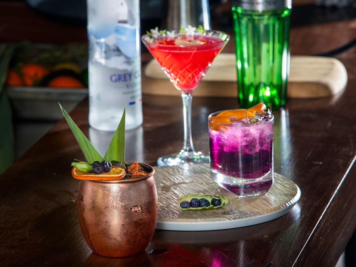 Cocktail glasses & bottles on a table in Coco Bar at Senses