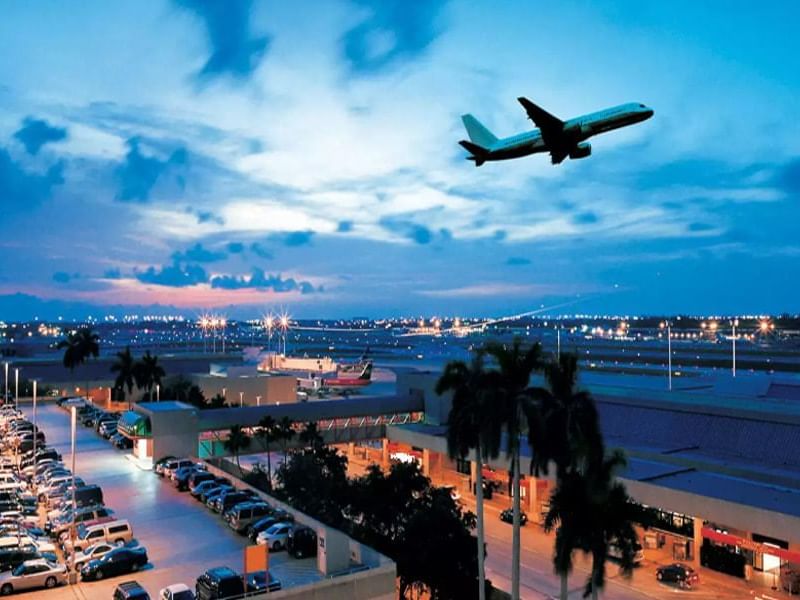 airplane taking off into evening sky