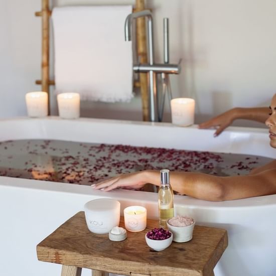 A girl enjoying a rose bath at Pullman Port Douglas sea temple resort and spa 