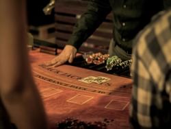 A man focused on playing blackjack at a casino near La Galerie Hotel