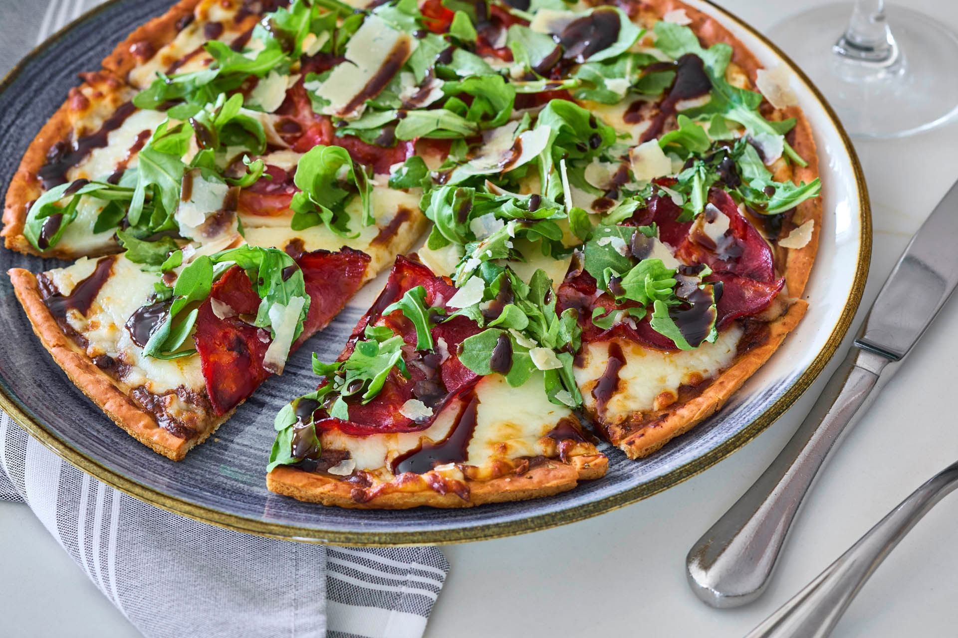 Enjoying a gourmet pepperoni and arugula pizza, celebration Florida restaurants while staying at Inn at Celebration