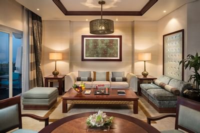 Lounge with sofas and table in a Deluxe suite at Ajman Hotel