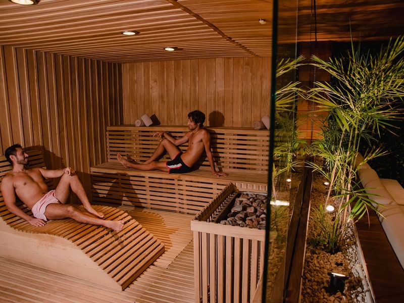 Men relaxing inside a sauna at The Reef 28