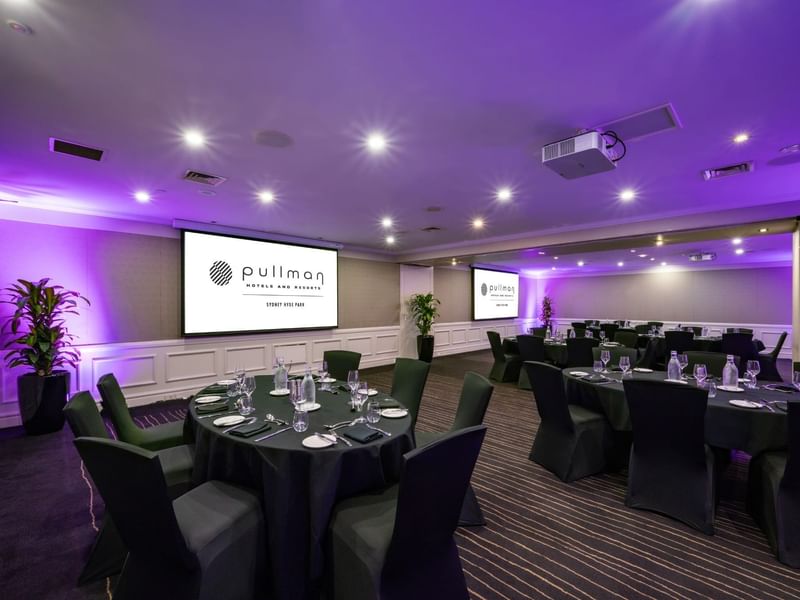 Banquet set-up with projector screens in Cook Room at Pullman Sydney Hyde Park