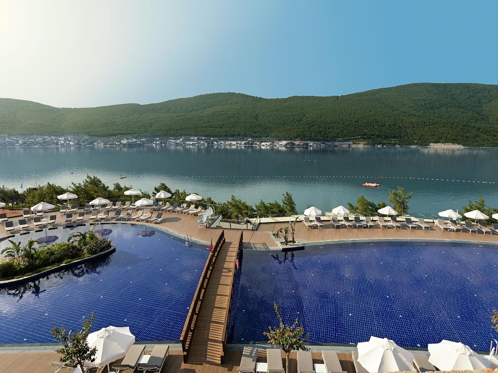 At Titanic Luxury Collection Bodrum, the sea-view outdoor pool offers tranquility with sun loungers and umbrellas.
