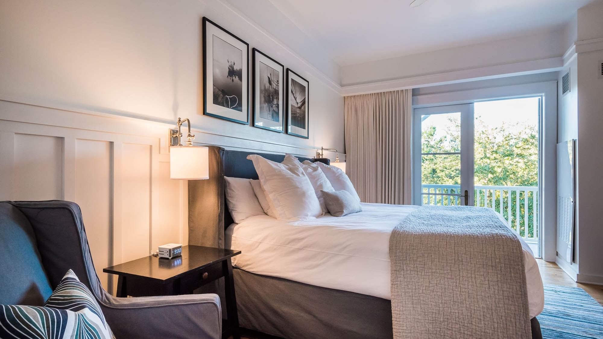 Comfy bed with an outdoor view in the Resort Suite at Watersound Inn