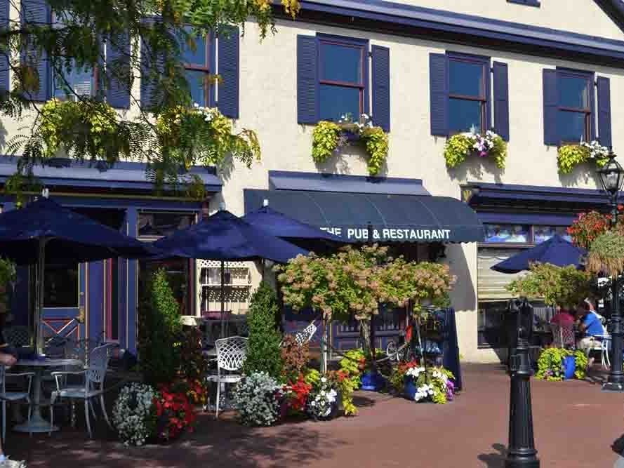 patio area of pub and restaurant with flowers and outdoor seating