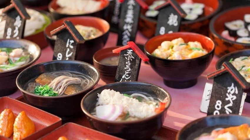 Various traditional Japanese dishes in bowls with Japanese signage at Park Hotel Group