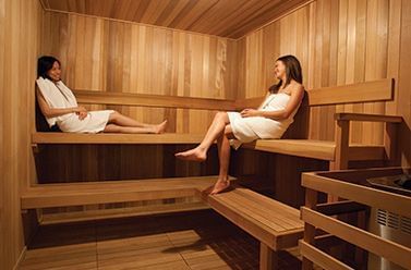 Two ladies relaxing in a sauna room at Aava Whistler Hotel