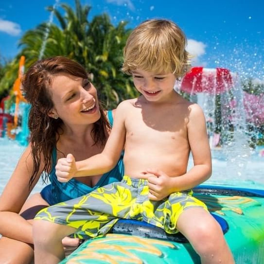 A mother and son play at a splash pad in Aquatica, soon to be home to Turi's Kid Cove.