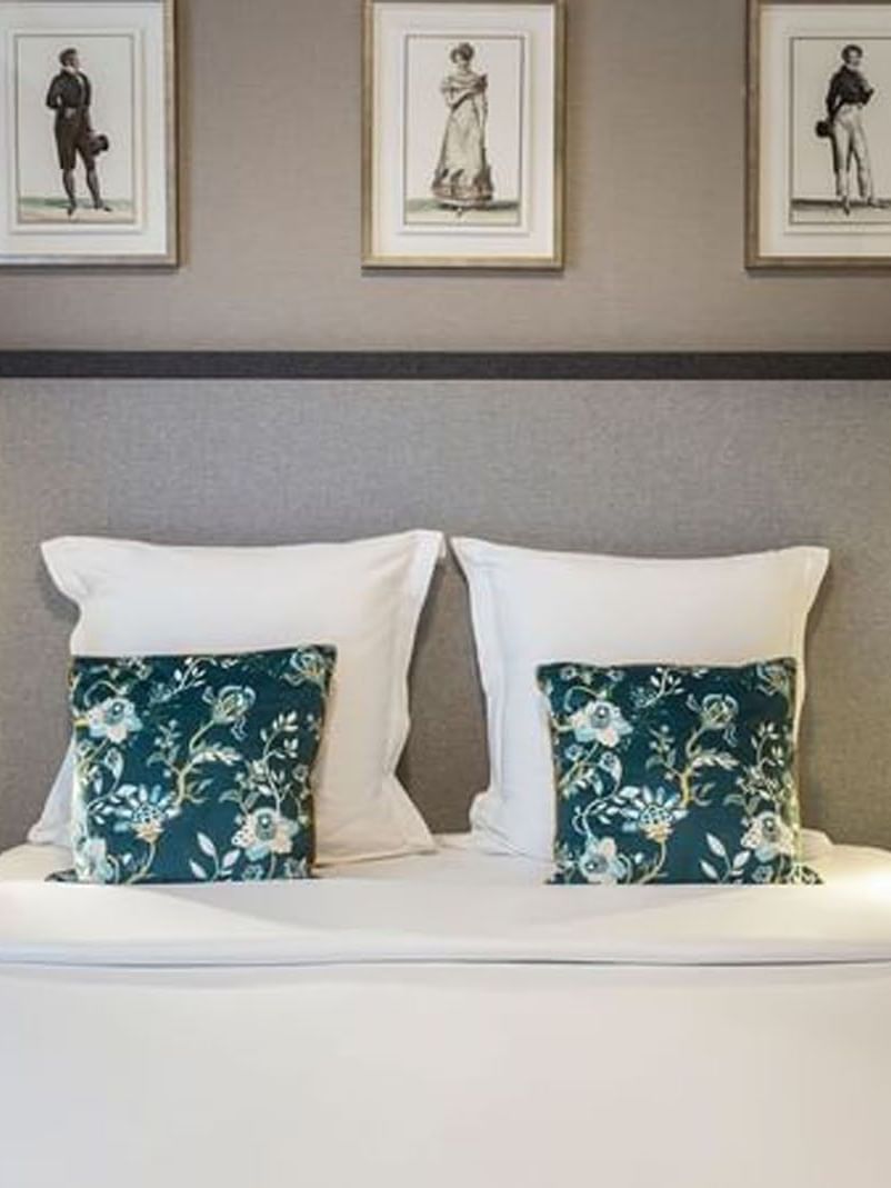 Cozy bed with a cushioned headboard and nightstands in the Premium Suite at Warwick Reine Astrid - Lyon