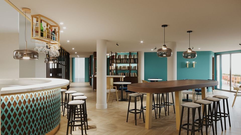 Bar counter & lobby area with book shelves at Portico84