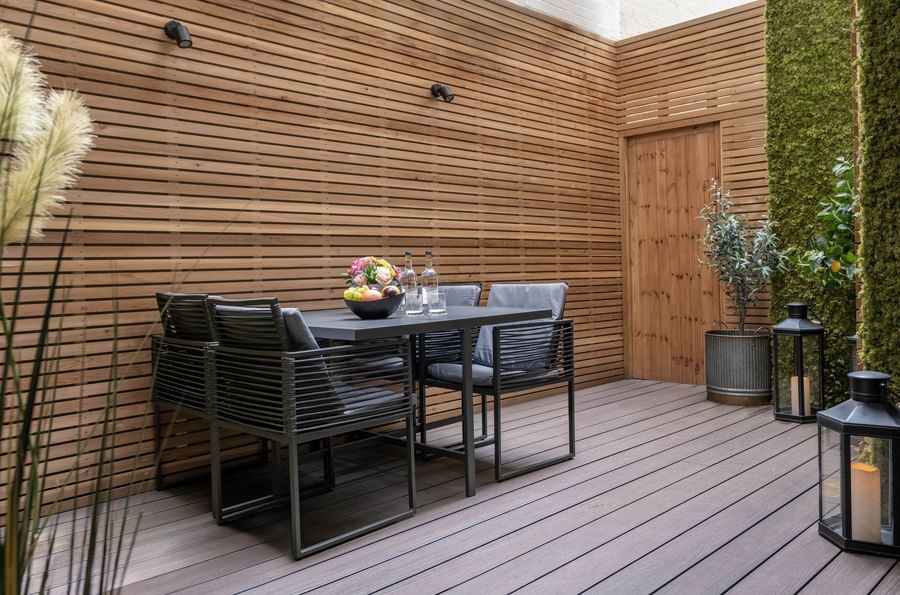 Wooden patio seating area in Hyde Park Suite at The Capital Hotel, Apartments and Townhouse