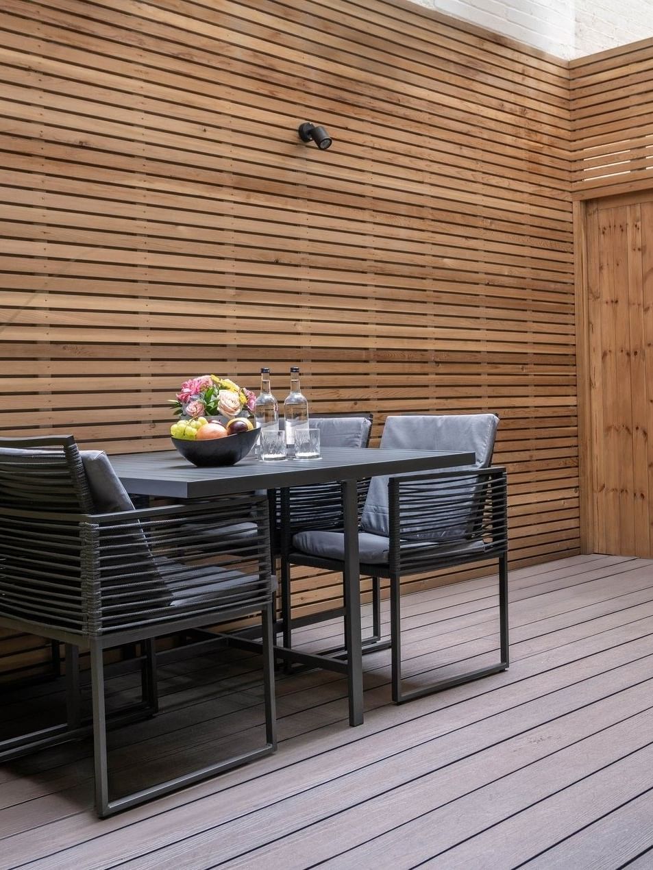 Wooden deck with table and chairs in Hyde Park Suite at The Capital Hotel, Apartments & Townhouse
