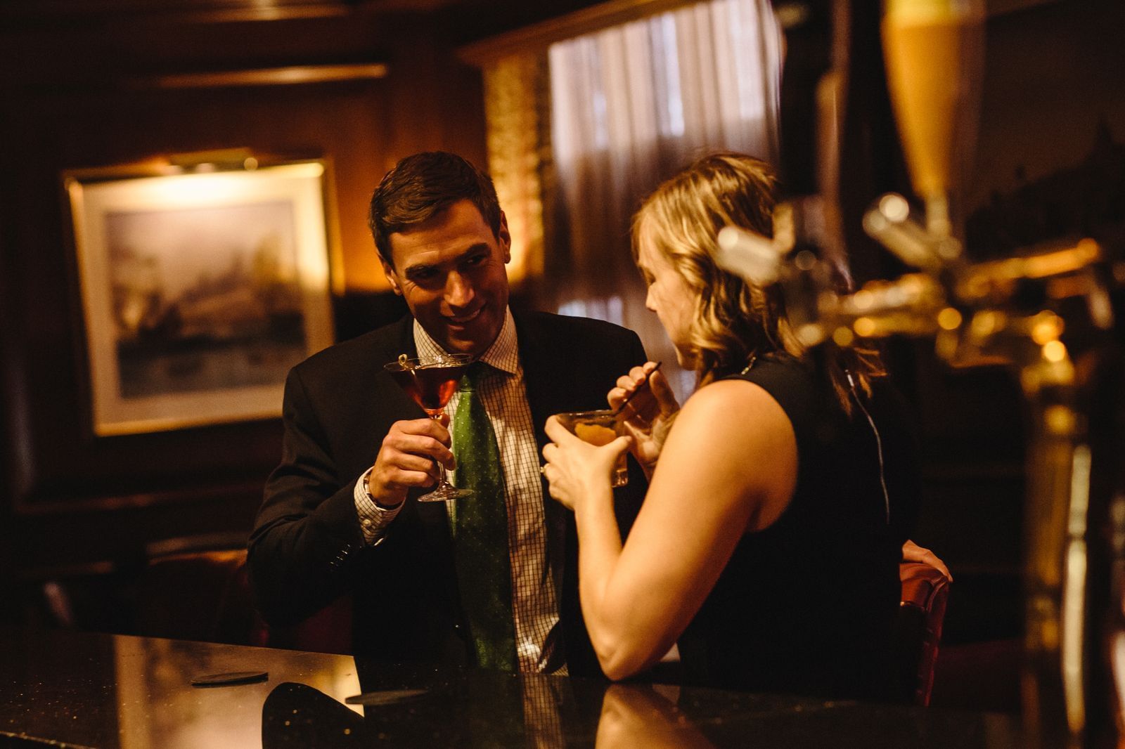 Two guests chatting and sipping cocktails at Rowes Wharf Bar
