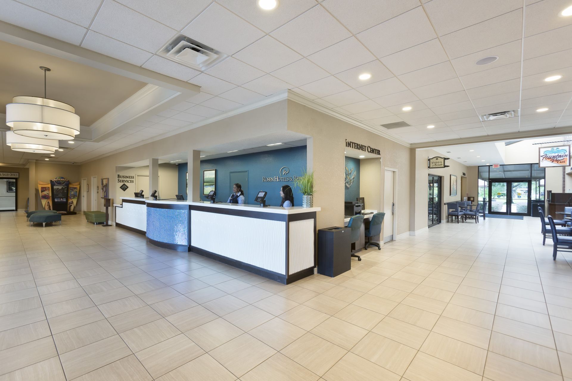Receptionists by the desk in the lobby, Rosen Inn International