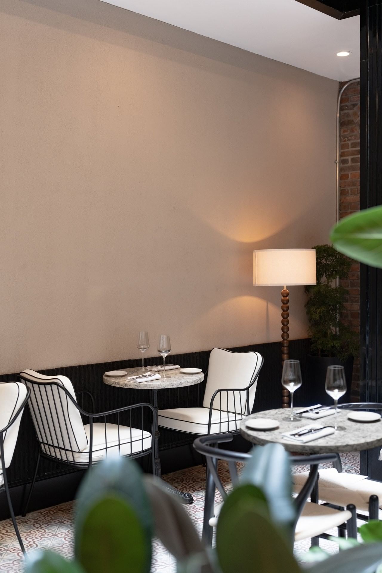 A dining area with tables and chairs set for a meal.