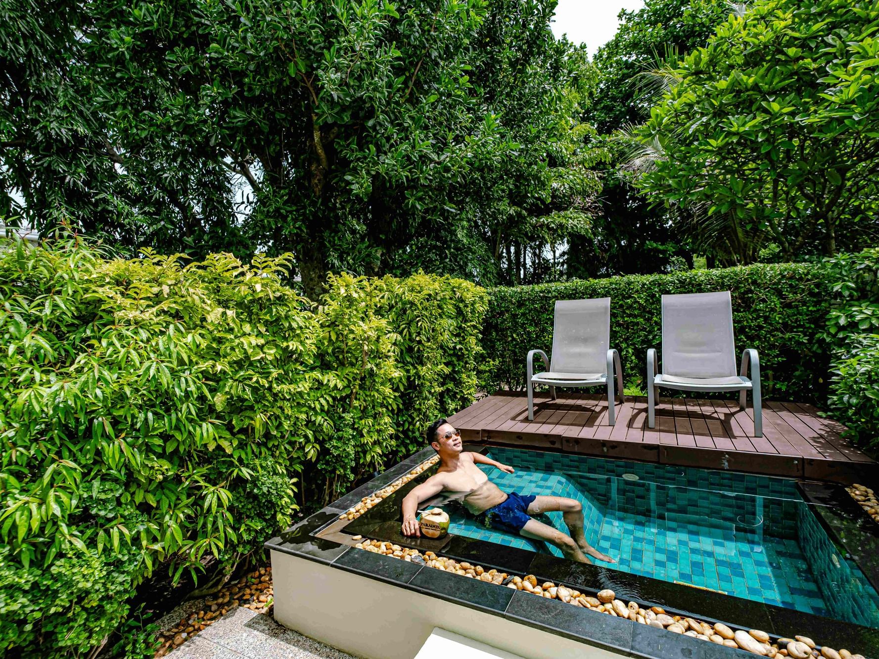 A man is soaking the good vibes in the Plunge Pool with garden view