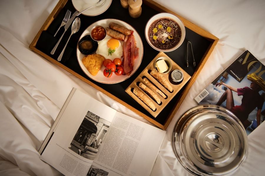 Full English breakfast served on a wooden tray at The May Fair Hotel, London