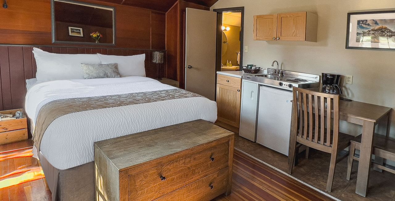 Cabin with bed, table, and kitchen