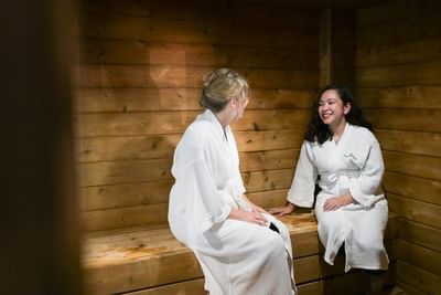 Guests relaxing in the wooden sauna at Rodd Grand Yarmouth, a premier Yarmouth hotel with pool and spa amenities