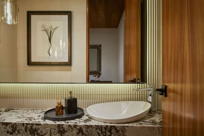 Bathroom with a marble vanity, a modern sink, and a framed painting, in Casa Cielo at Singular Signature Residences