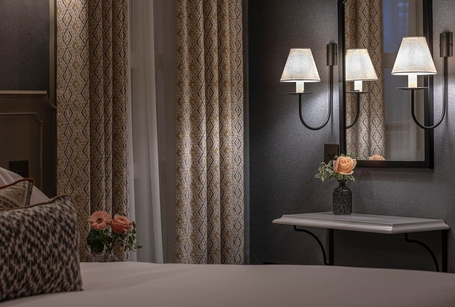 Bed with vanity table near window in Hyde Park Suite at The Capital Hotel, Apartments and Townhouse