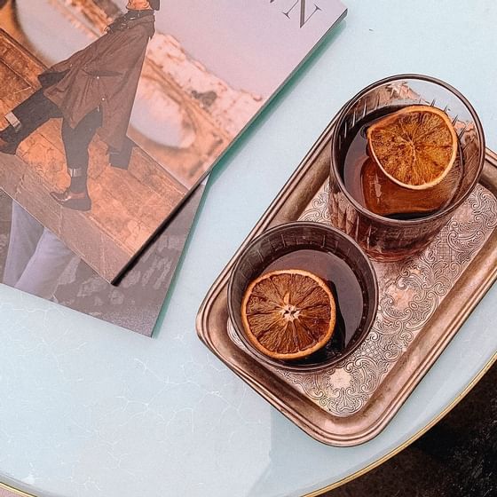 Close-up of iced tea beside two magazines at ReStays Ottawa