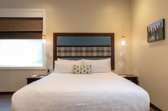 Pillows on a bed in Canada-themed Room at The Whittaker Inn