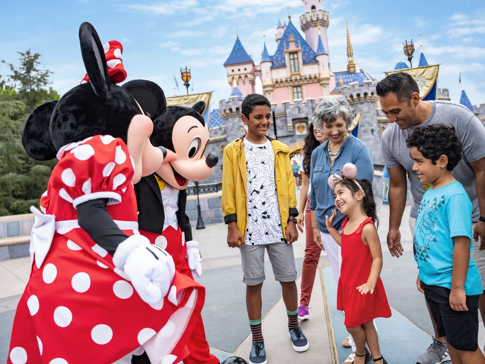 Family chatting with Mickey & Mini mouse at Disneyland near Anaheim Portofino Inn & Suites