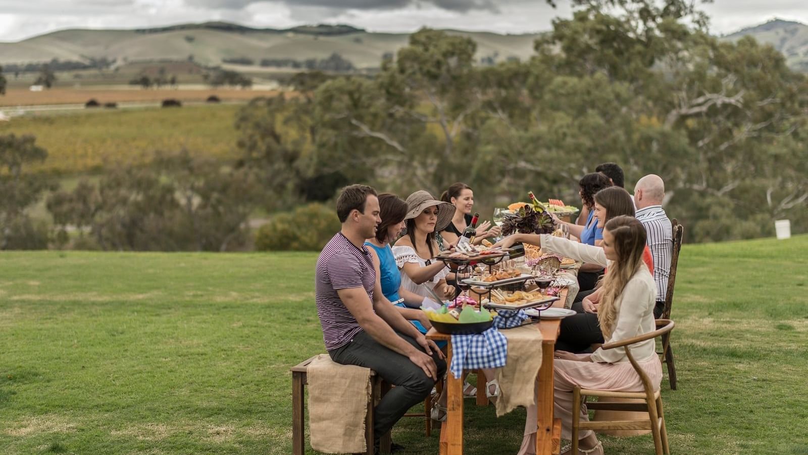 Group of friends enjoying food in outside at Novotel Barossa