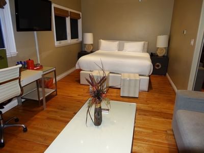 king bedroom with desk and flat-screen tv