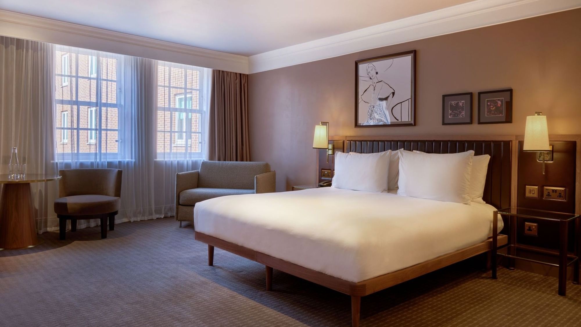 Elegant room with large bed and window at The May Fair Hotel in London.
