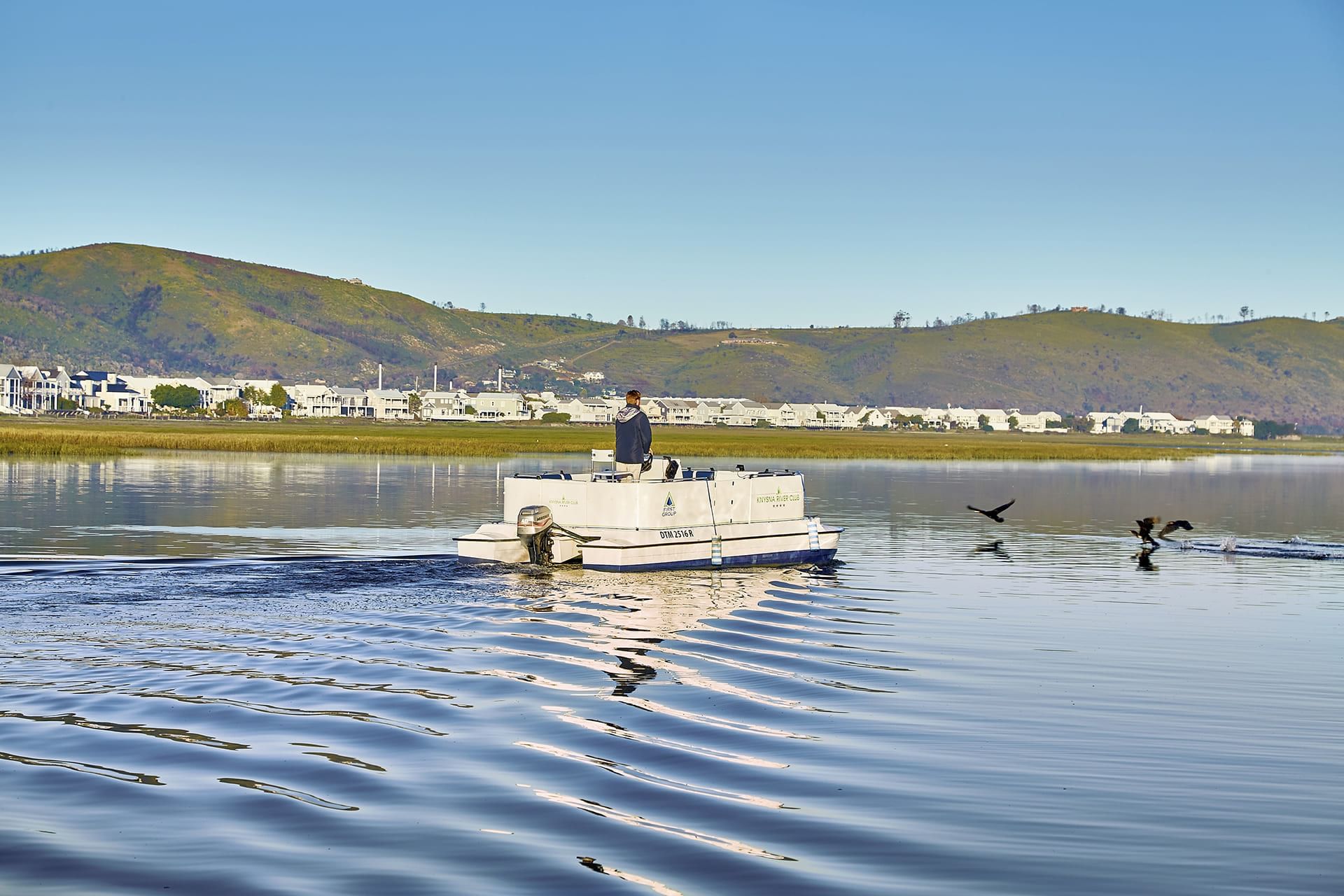 A man on a boat at the lake near Knysna River Club