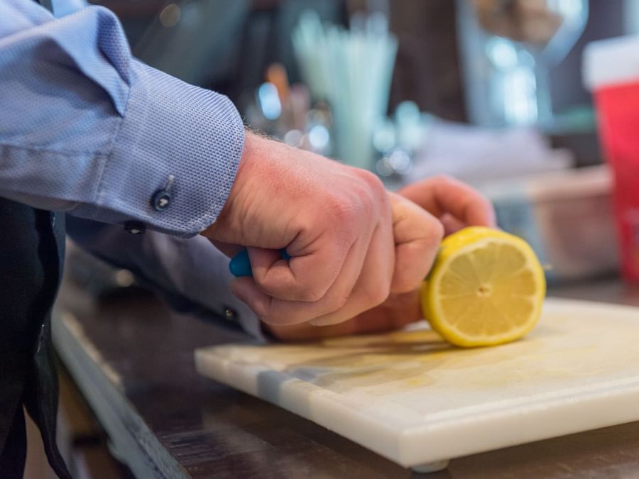 A chef chopping a lemon at Moulin de daverdisse