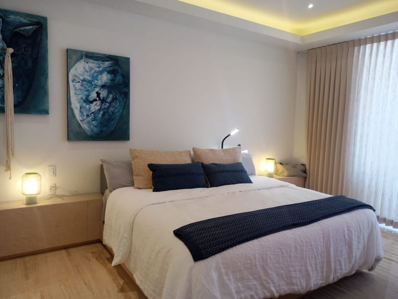 Room interior with queen bed and wall arts at Live Aqua Private Residences La Paz