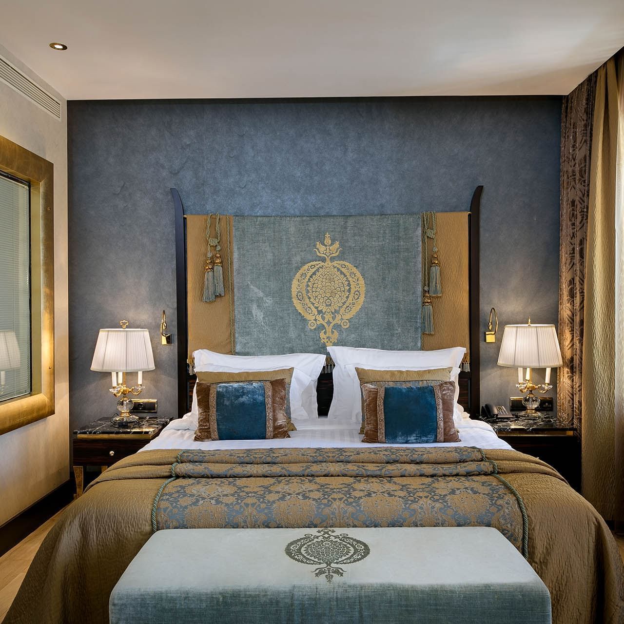 Cozy bed with side tables in Deluxe Room at Titanic Mardan Palace