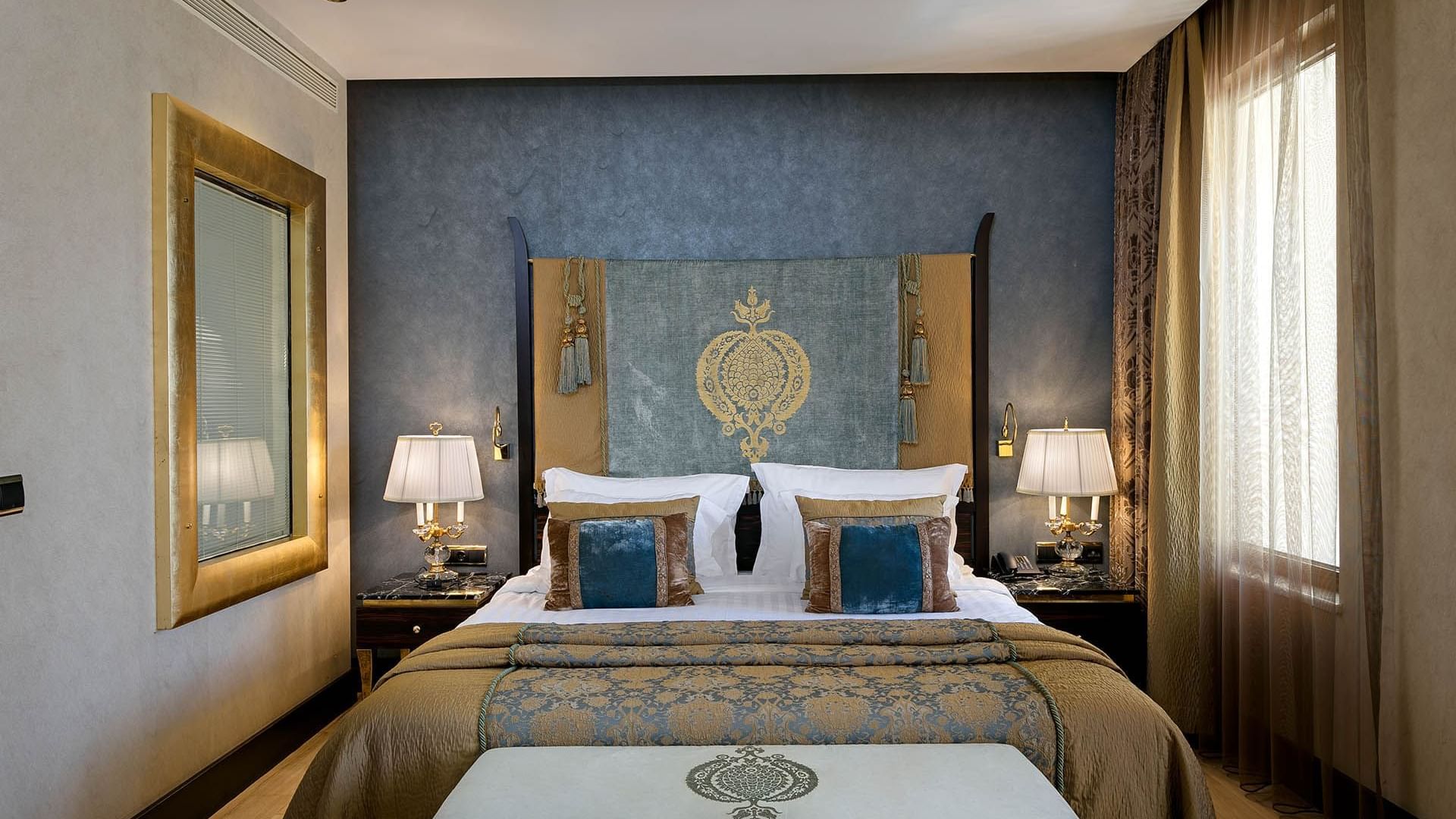 Cozy bed with side tables in Deluxe Room at Titanic Mardan Palace