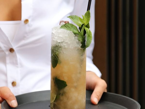 A waitress serving a Mojito in a restaurant, Warwick Le Crystal