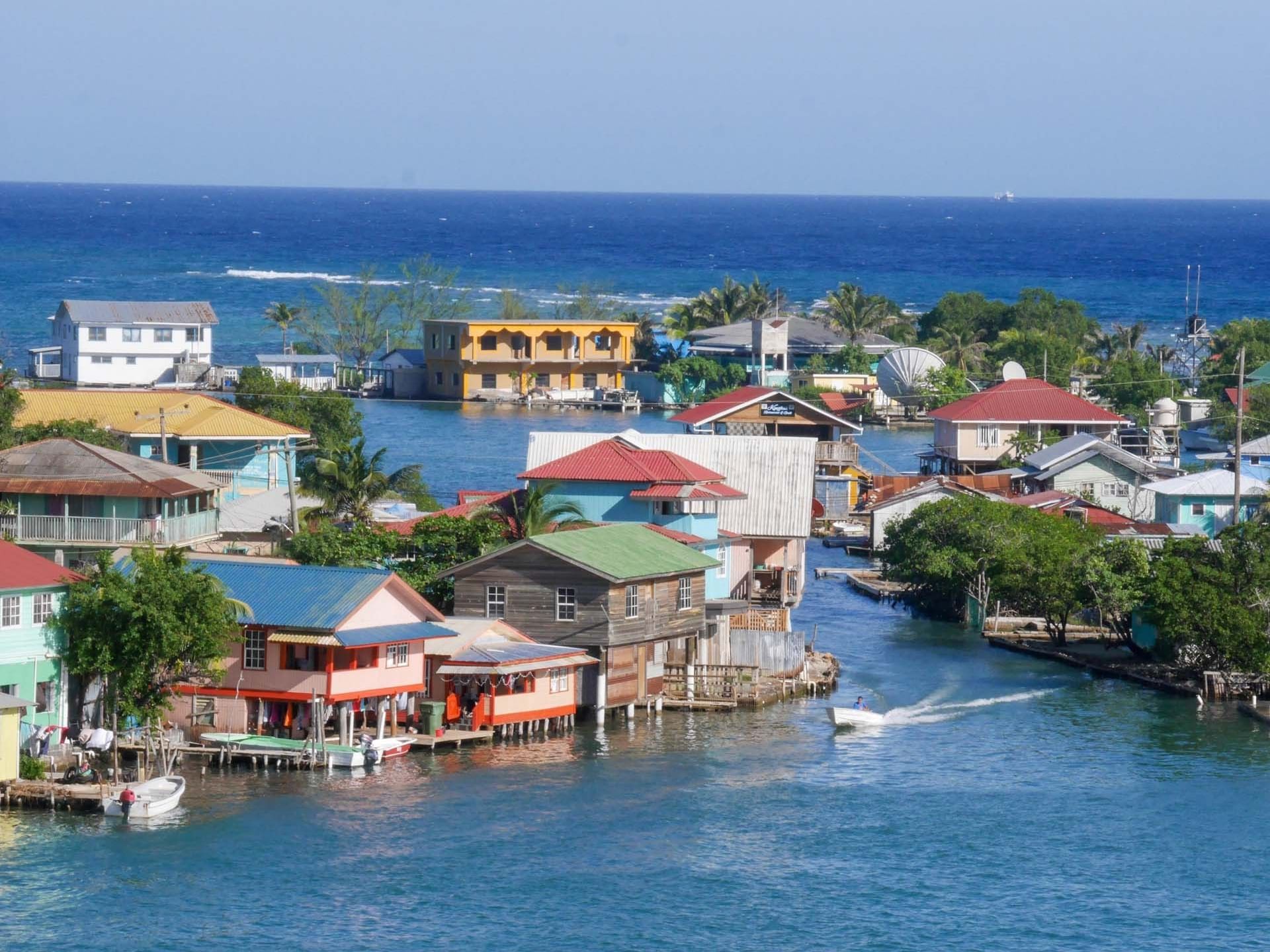 Colorful houses on stilts along the water near Barefoot Cay Resort & Marina