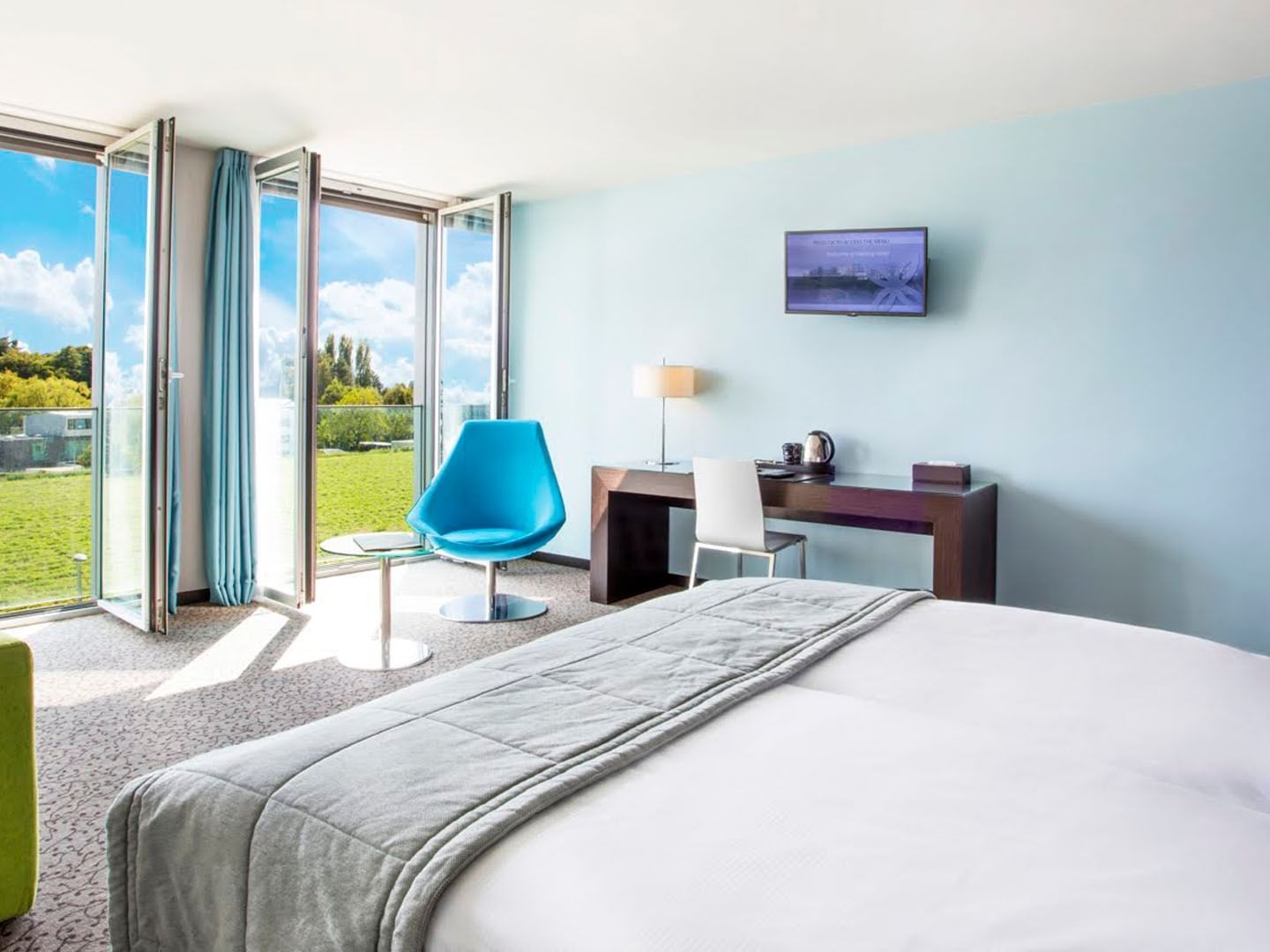 Bedroom with open windows overlooking the garden at Starling Hotel Lausanne hotel deals