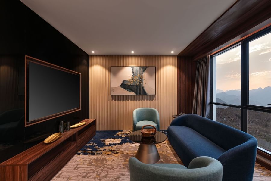 TV lounge with plush sofa by the window in Royal Suite at Warwick Al Taif Hotel