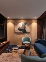 TV lounge with plush sofa by the window in Royal Suite at Warwick Al Taif Hotel
