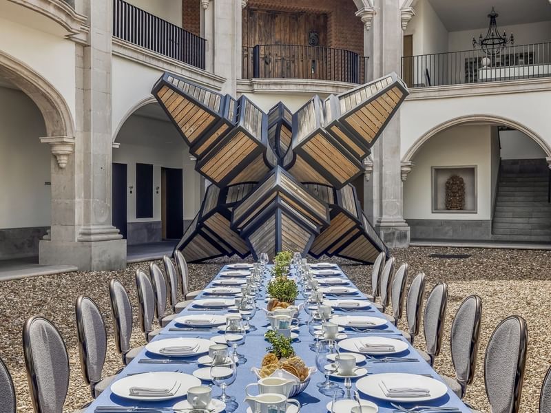Outdoor royal banquet table arranged with glassware at Live Aqua San Miguel de Allende