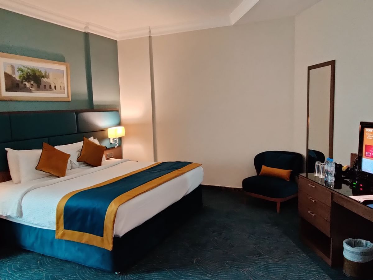 Bed & dressing table in Seasons Suite at City Seasons Hotels