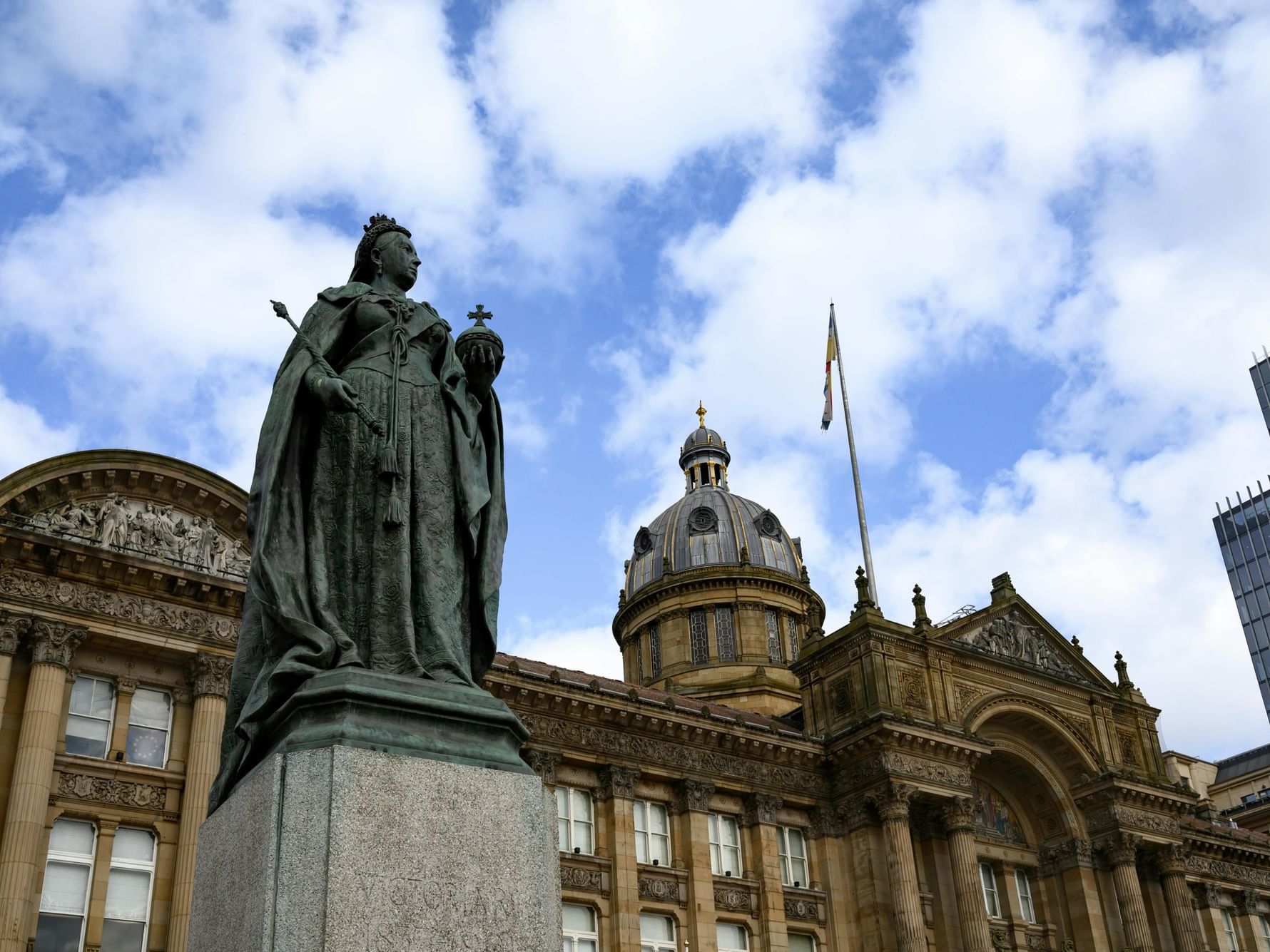 Statue of Queen Victoria in front of Birmingham City Council building under blue sky